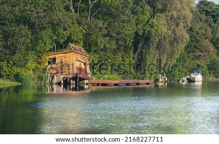 Decrepit boathouse on the Pefferlaw river. Royalty-Free Stock Photo #2168227711