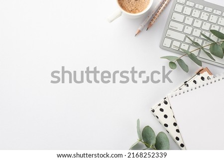 Business concept. Top view photo of workplace keyboard stylish notepads pencils cup of hot drinking and eucalyptus sprig on isolated white background with empty space