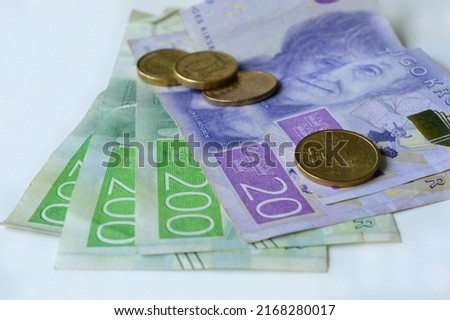 money lying on a white table, two hundred Swedish Kronor, twenty Swedish Kronor and coins Royalty-Free Stock Photo #2168280017