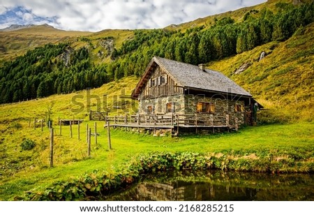 A lonely hut in the mountains. Hut in mountains. Stone hut on hill Royalty-Free Stock Photo #2168285215