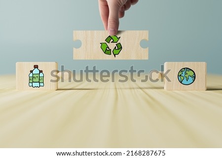 Wooden blocks with eco icons such as a trash can, planet Earth, PET plastic bottles and recycling. Concept of recycling, caring for the planet, waste processing. Taking care of the environment.