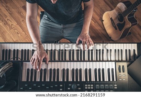 Male musician plays the piano, top view, hands.