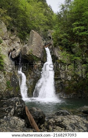 Rocks and boulders frame the majestic waterfall at Bash Bish Falls Royalty-Free Stock Photo #2168297093