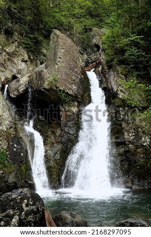 Rocks and boulders frame the majestic waterfall at Bash Bish Falls Royalty-Free Stock Photo #2168297095