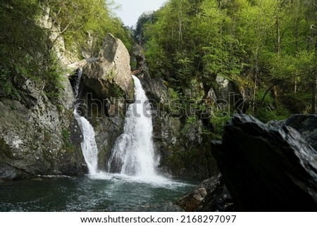 Rocks and boulders frame the majestic waterfall at Bash Bish Falls Royalty-Free Stock Photo #2168297097