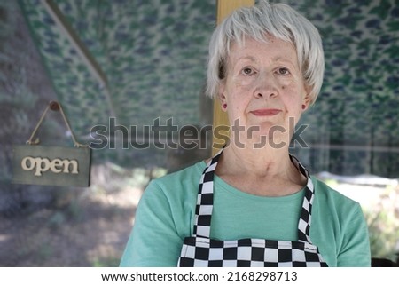 Senior female worker wearing an apron