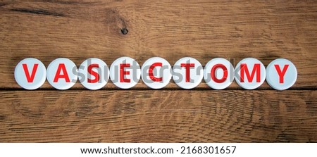 Vasectomy symbol. Concept words Vasectomy on white circles. Beautiful wooden table wooden background. Medical and vasectomy problem concept. Conceptual image. Copy space.