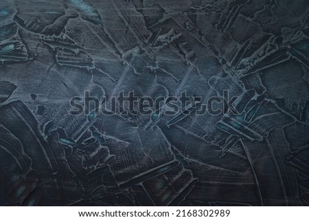 Background from dark blue texture. Dark textured background with blue light. Background with central illumination. Front view.