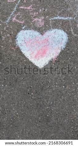 heart drawn in chalk on asphalt