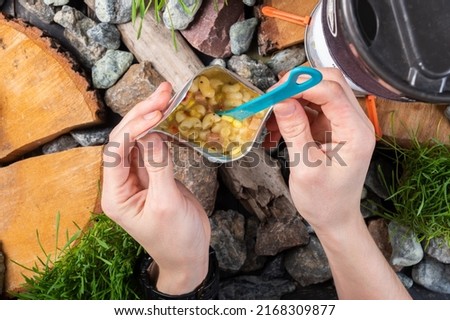 Cooked tourist food. Freeze-dried pasta in a bag. Food for tourists. Food is in the hands of the tourist. Tourist composition. Royalty-Free Stock Photo #2168309877