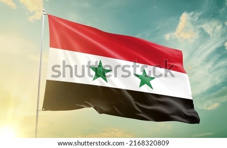 Syria national flag waving in beautiful clouds.
