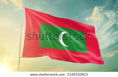 Maldives national flag waving in beautiful clouds.