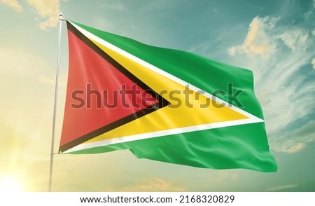 Guyana national flag waving in beautiful clouds.