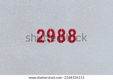 Red Number 2988 on the white wall. Spray paint.
