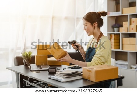 Happy Excited start up business woman using a barcode reader to check parcels before shipping to customers who buy online. Royalty-Free Stock Photo #2168327965