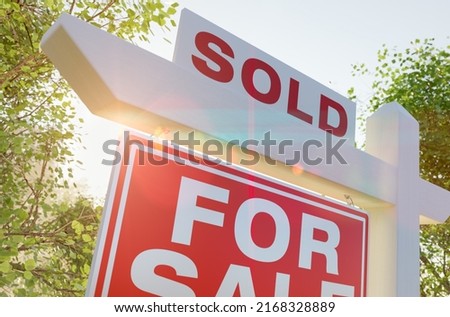 Sold For Sale Real Estate Sign In Front of Property.