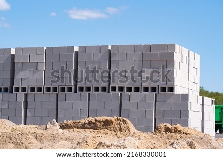 stacks of concrete blocks on pallets at a construction material wearhouse ready for sale concrete blocks are widely used in building construction site Royalty-Free Stock Photo #2168330001
