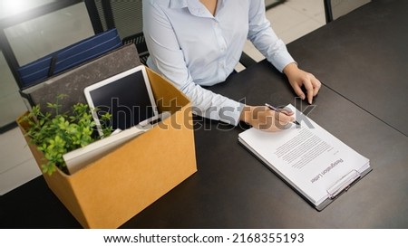 Resignation concept, Female employee sign resignation letter before sending to boss when quit job.