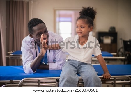 African American pediatric doctor with kids patient in hospital, African American male pediatrician Royalty-Free Stock Photo #2168370501