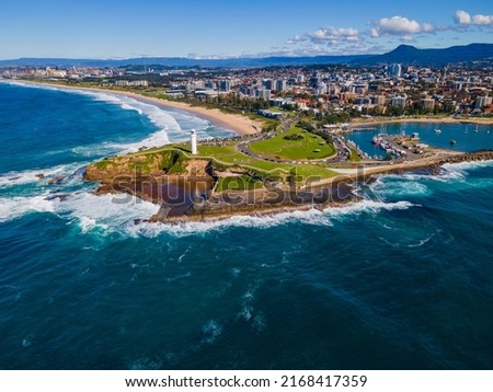 Aerial drone view of Flagstaff Point Lighthouse at Wollongong on the New South Wales South Coast, Australia with Wollongong city in the back ground on a sunny day    Royalty-Free Stock Photo #2168417359