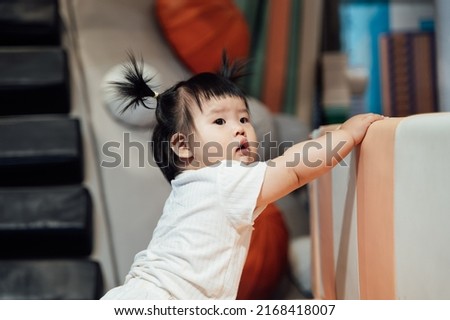 10 month old baby playing in amusement park Royalty-Free Stock Photo #2168418007