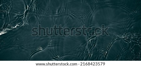 Black transparent clear calm water surface texture with ripples, splashes. Abstract nature banner background. Dark grey water waves. Copy space, top view. Cosmetic moisturizer micellar toner emulsion Royalty-Free Stock Photo #2168423579