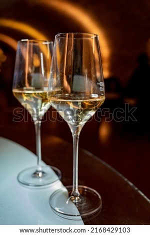Tasting of brut champagne sparkling wine produced by traditional method in underground caves close up Royalty-Free Stock Photo #2168429103