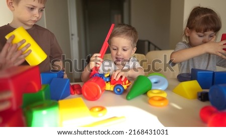 kindergarten. a group of children play toys cubes and cars on the table in kindergarten. kid dream creative happy family preschool education lifestyle concept. nursery baby toddler home
