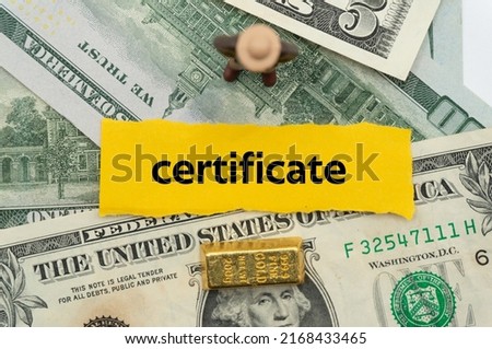 certificate.The word is written on a slip of paper,on colored background. professional terms of finance, business words, economic phrases. concept of economy.