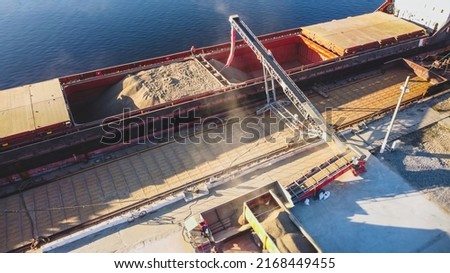 Aerial view of big grain elevators on the sea. Loading of grain on ship. Port Ukraine. Cargo ship Royalty-Free Stock Photo #2168449455