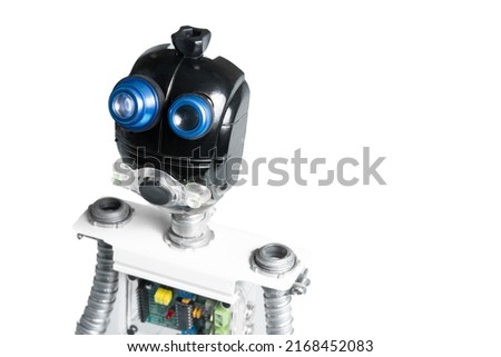 Close-up of DIY robot and microcontrollers board in robotics laboratory school. Humanoid robot standing on white background