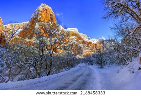 Snowy road through winter canyon. Canyon snowy road. Snowy road in canyon. Canyon road in snow Royalty-Free Stock Photo #2168458333