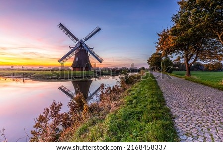 Windmill in Holland. Mill by the river at dawn. Windmill at dawn Royalty-Free Stock Photo #2168458337