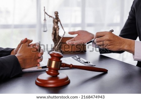 justice and law concept. male lawyer working in an office. Legal law, advice, and justice concept. The client is bringing the documents to clarify the law to the lawyer at the prosecutor's office.	
