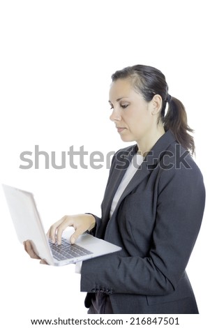 business woman standing using a laptop isolated on a white background - focus on the face