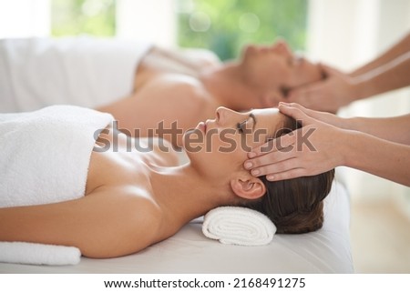 Pure relaxation. Closeup shot of a young woman and her husband receiving head massages at a spa. Royalty-Free Stock Photo #2168491275