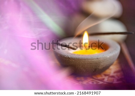Just lay back, relax and set your body free - Spa Treatments. Shot of incense and a candle.