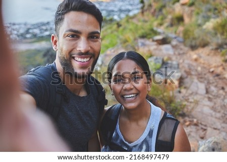 Youre my favourite person to hike with. Shot of a young couple taking photos while out on a hike in a mountain range outside.