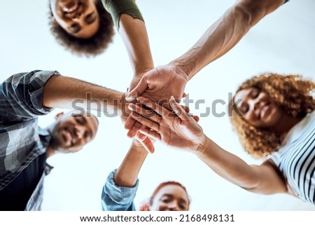 The team that dreams continuously achieves. Low angle shot of a group of businesspeople joining their hands together in a huddle. Royalty-Free Stock Photo #2168498131