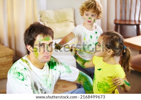 Babysitting is not for the fainthearted. Shot of a dad being painted by his children. Royalty-Free Stock Photo #2168499673