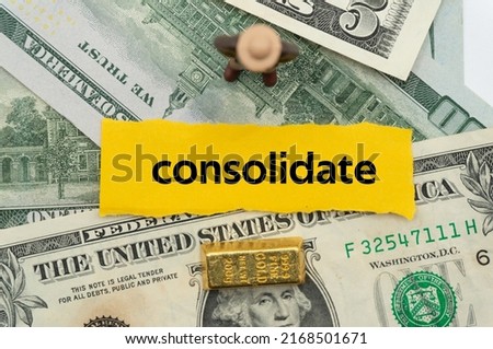 consolidate.The word is written on a slip of paper,on colored background. professional terms of finance, business words, economic phrases. concept of economy.