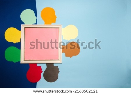 world people day, old frame with pink copy space around which colorful human heads are on a blue background of different shades, world population day