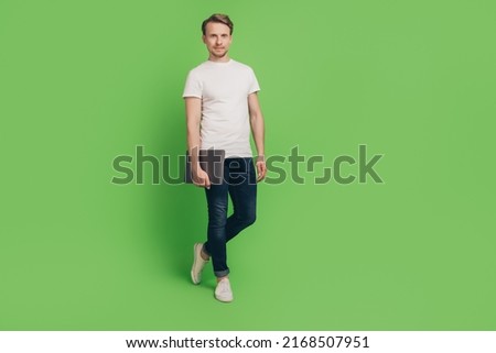 Photo of freelancer programmer man hold laptop prepare remote work wear white t-shirt on green color background