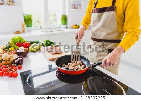 Cropped close up photo of young man fry meat pan kitchen cuisine restaurant dish supper gourmet indoors Royalty-Free Stock Photo #2168507955