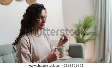 Vitamins and supplements - Woman holding pipette of CBD medical cannabis hemp oil - Healthy lifestyle  Royalty-Free Stock Photo #2168526621