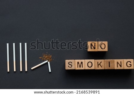 Broken cigarettes on a black background. Smoking kills