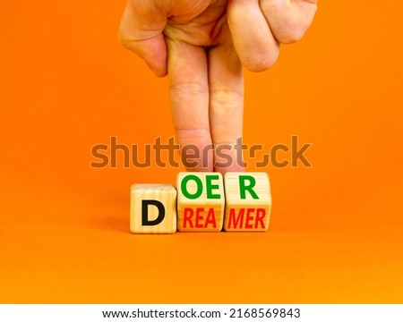 Doer or dreamer symbol. Concept words Doer or dreamer on wooden cubes. Businessman hand. Beautiful orange table orange background. Business and doer or dreamer concept. Copy space. Royalty-Free Stock Photo #2168569843