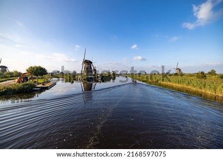 Horizontal picture of the famous Dutch windmills at Kinderdijk, a UNESCO world heritage site. On the photo are five of the 19 windmills at Kinderdijk, South Holland, the Netherlands, which are built