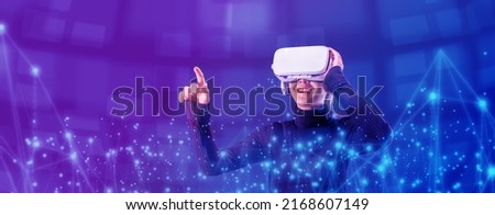 Asian woman wearing VR headset for entertainment in the metaverse. Augmented reality. Future digital technology game and entertainment. Metaverse technology concept.  Royalty-Free Stock Photo #2168607149