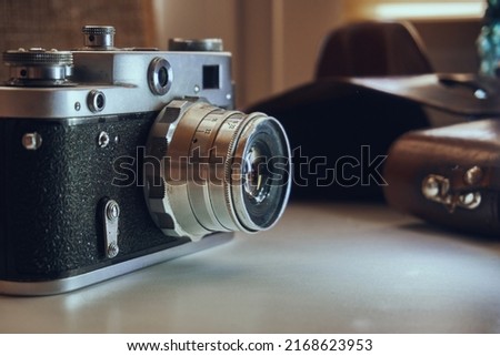 Film camera unknown model. Manual object. In the background is a leather case of cabura.